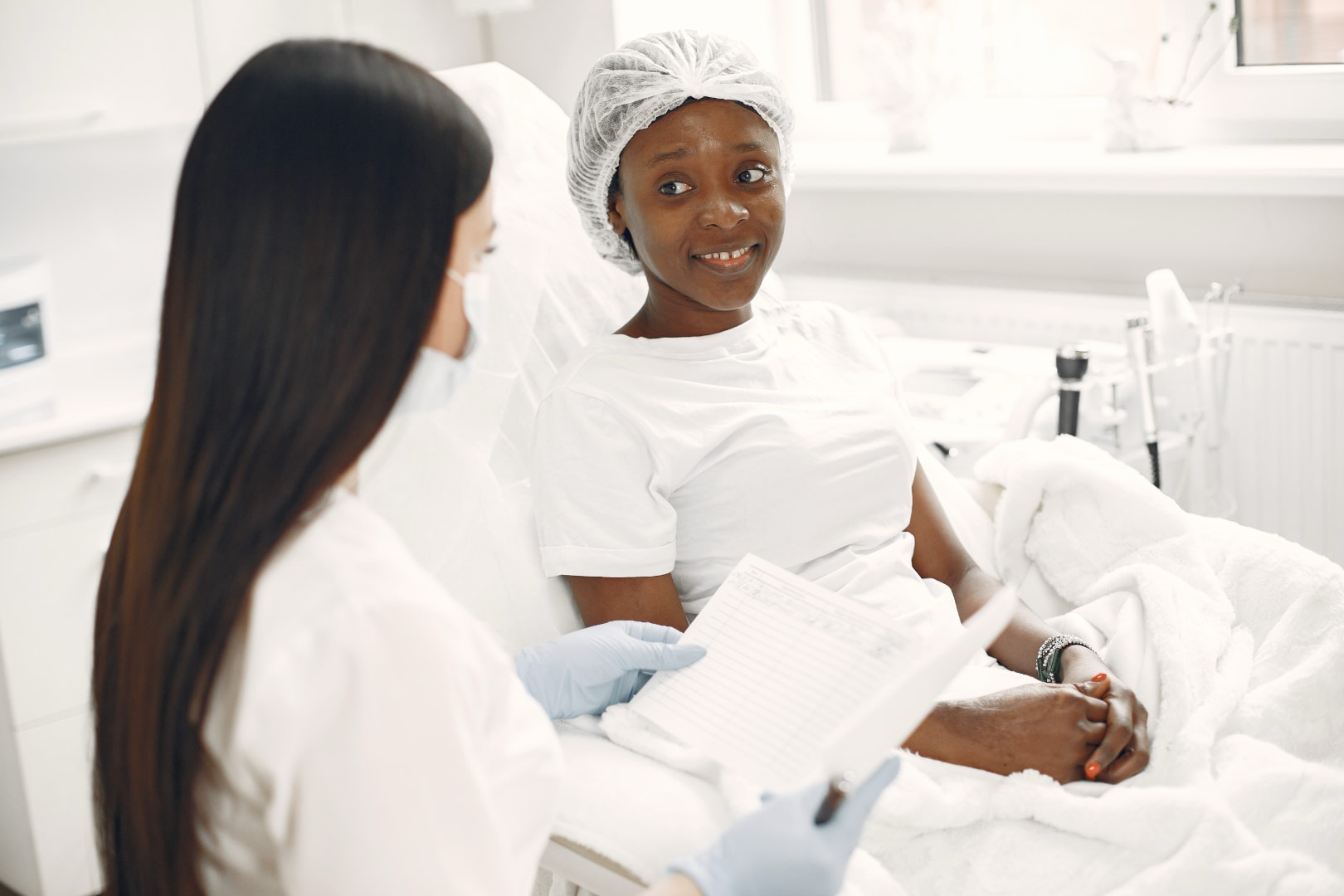 Woman discussing botulinum toxin aftercare with a doctor during a clinic consultation