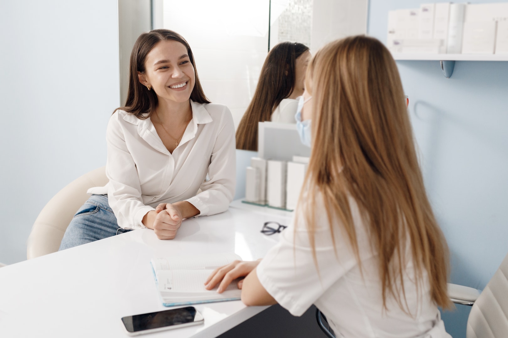 Woman discussing non-ablative laser treatment options with a clinician at a Bangkok clinic