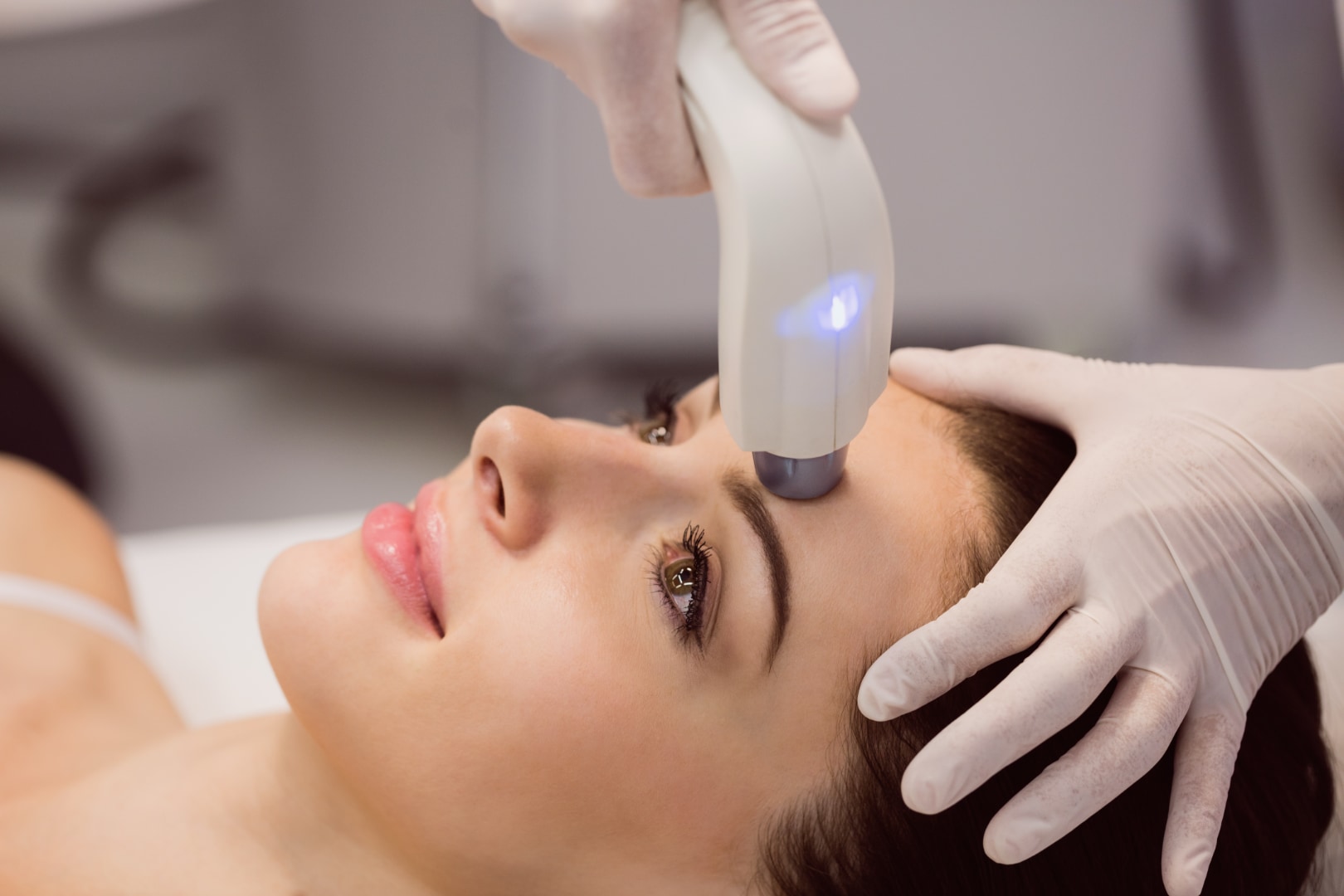 Patient receiving a Laser Genesis facial treatment with a handheld Nd:YAG laser