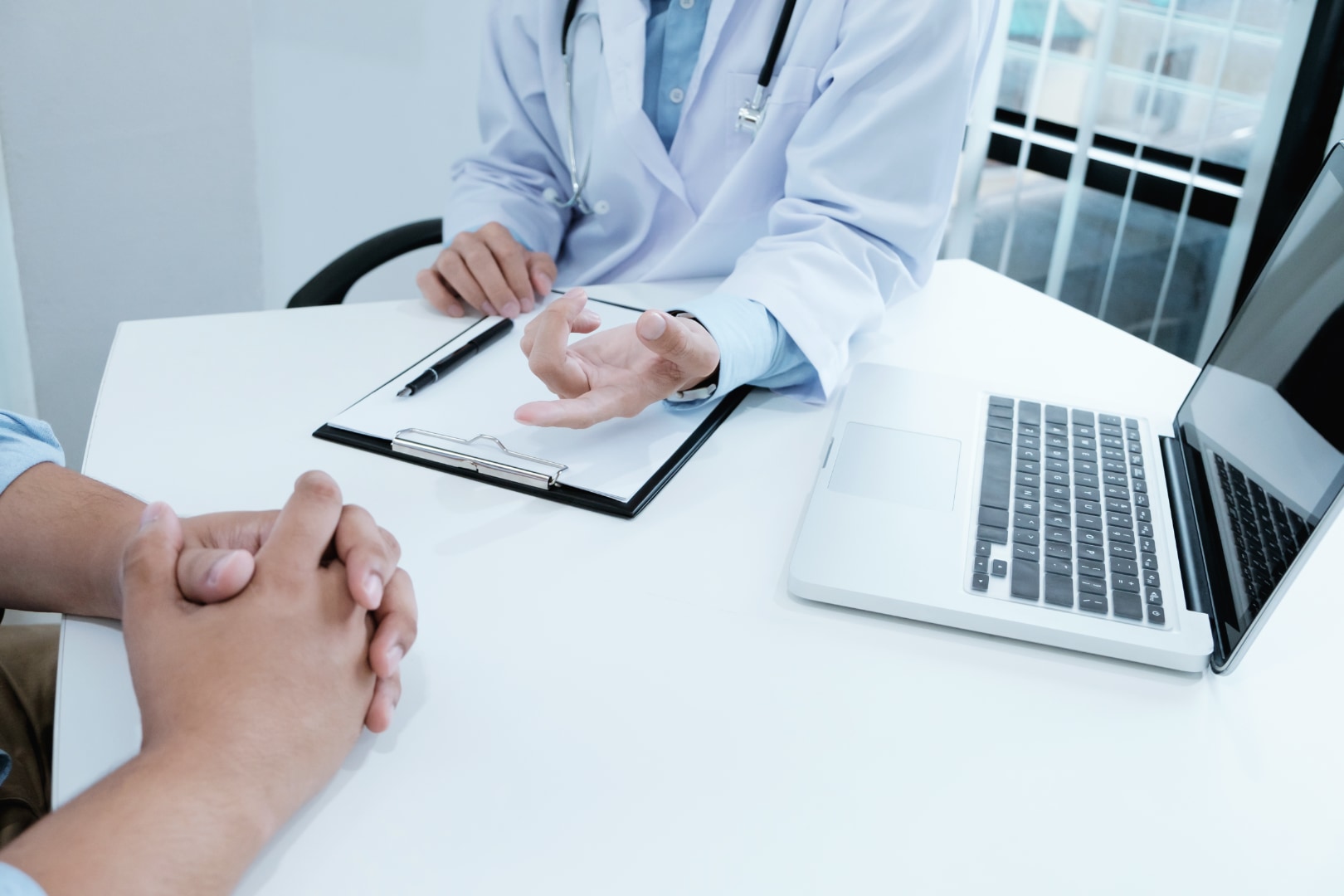 Doctor consulting a male patient about obtaining tadalafil in Thailand by prescription
